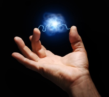 male hand with electricity arcing between thumb and middle finger with plasma ball suspended in the center